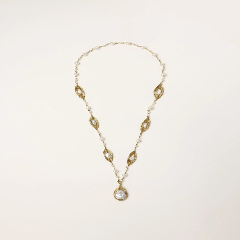 14K gold plated necklace with organic leaf motifs and freshwater pearls arranged in an elegant chain design on neutral background.