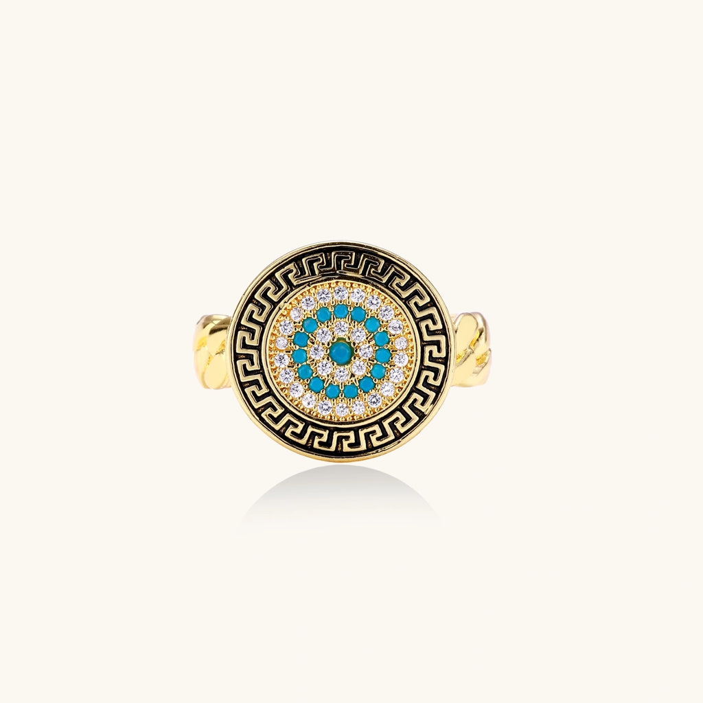 Gold chain ring with Greek key border and turquoise evil eye center on white background